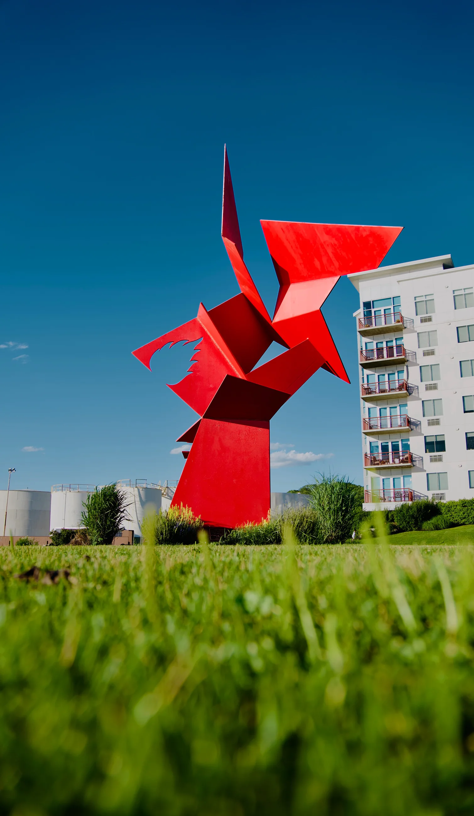 Angular red sculpture against a clear blue sky