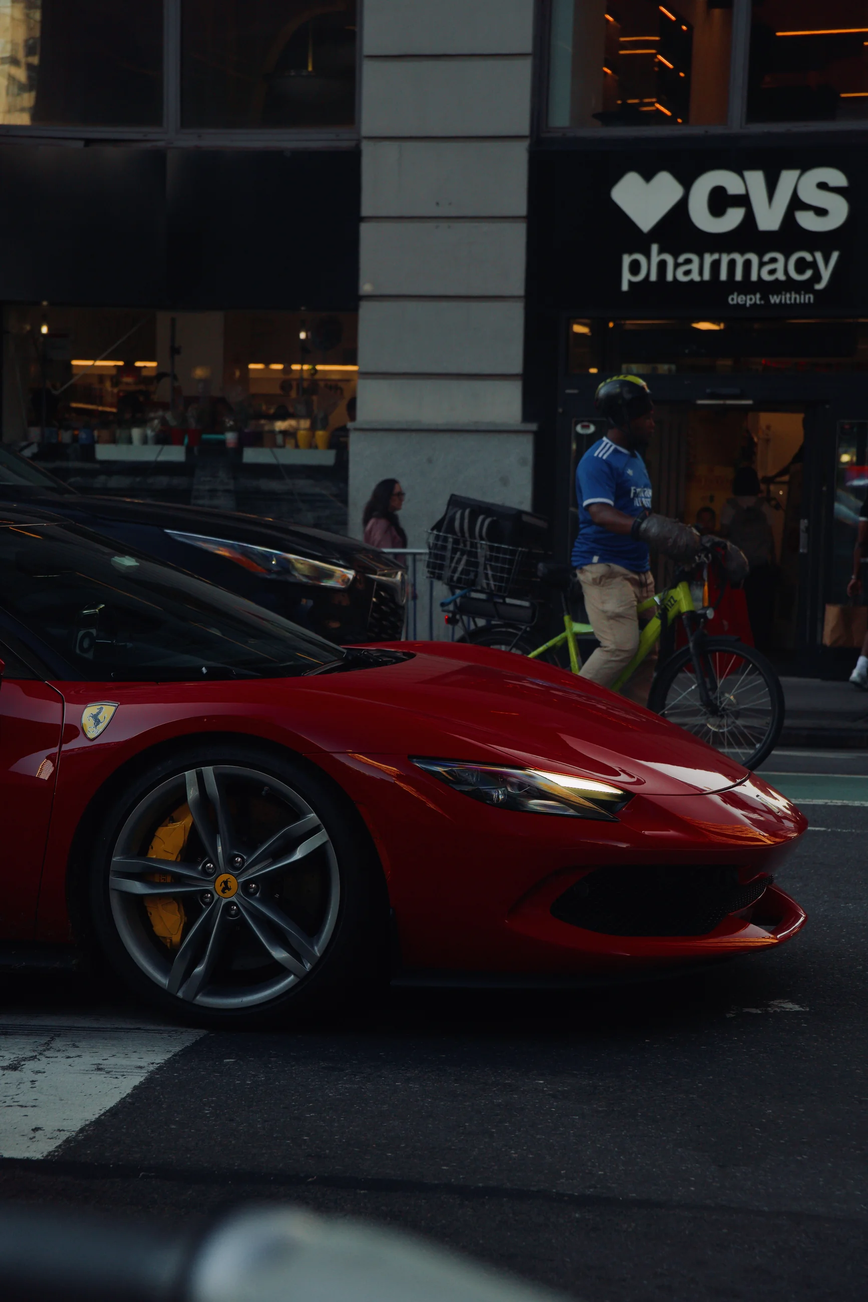 Red Ferrari parked along a city street