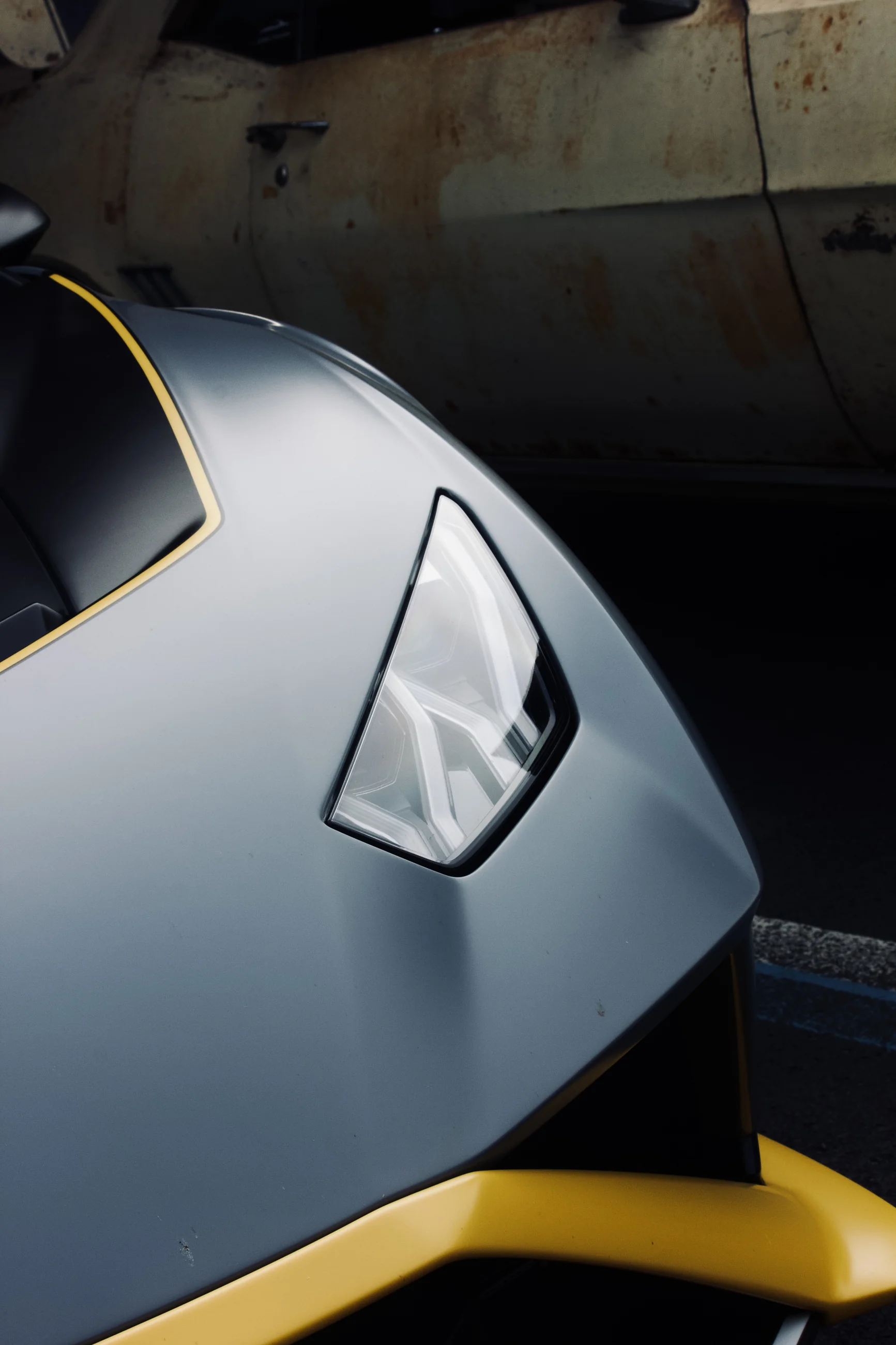 Close-up of a silver Lamborghini front corner and yellow splitter