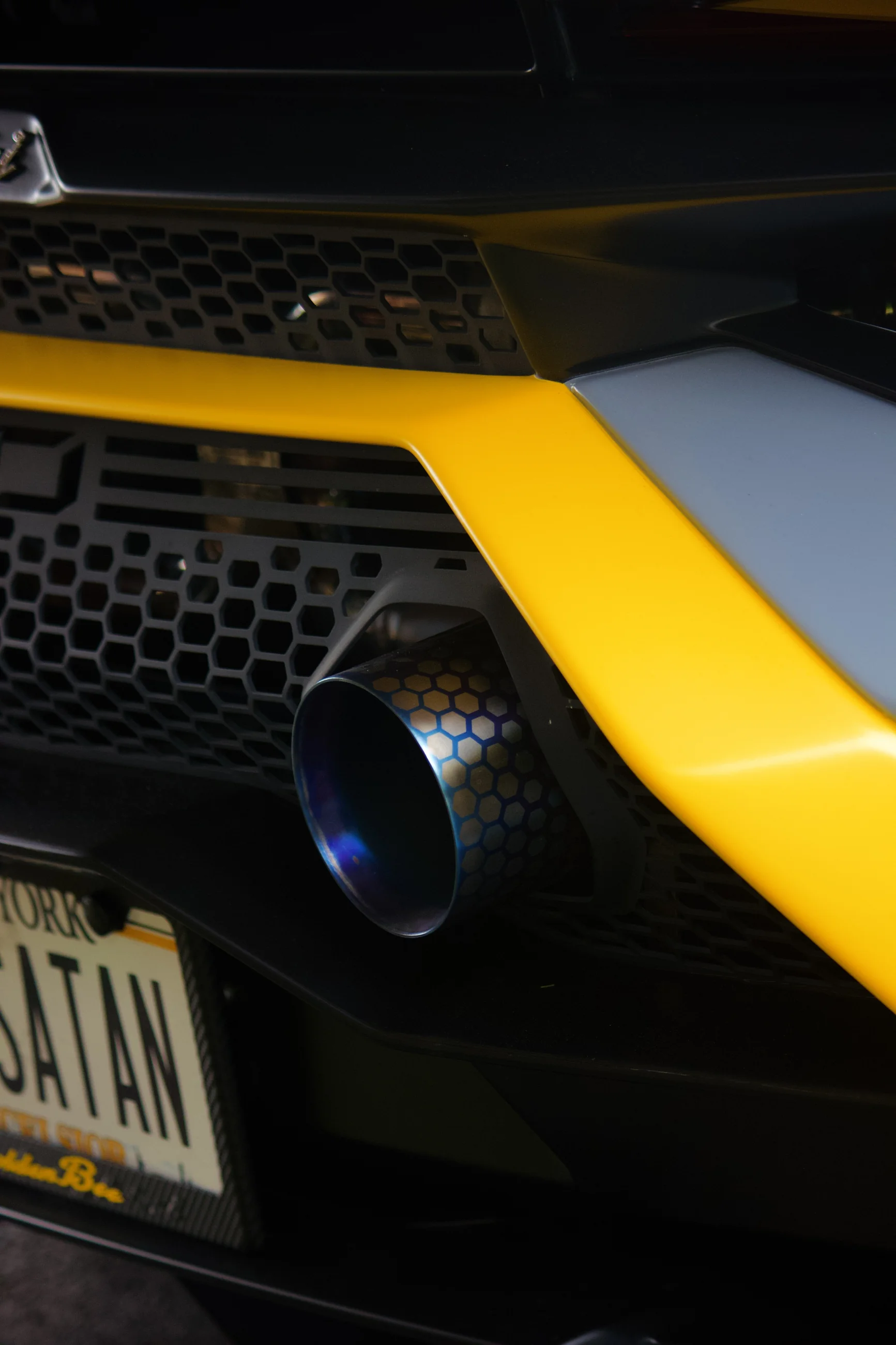 Rear grille and yellow bumper detail of a Lamborghini